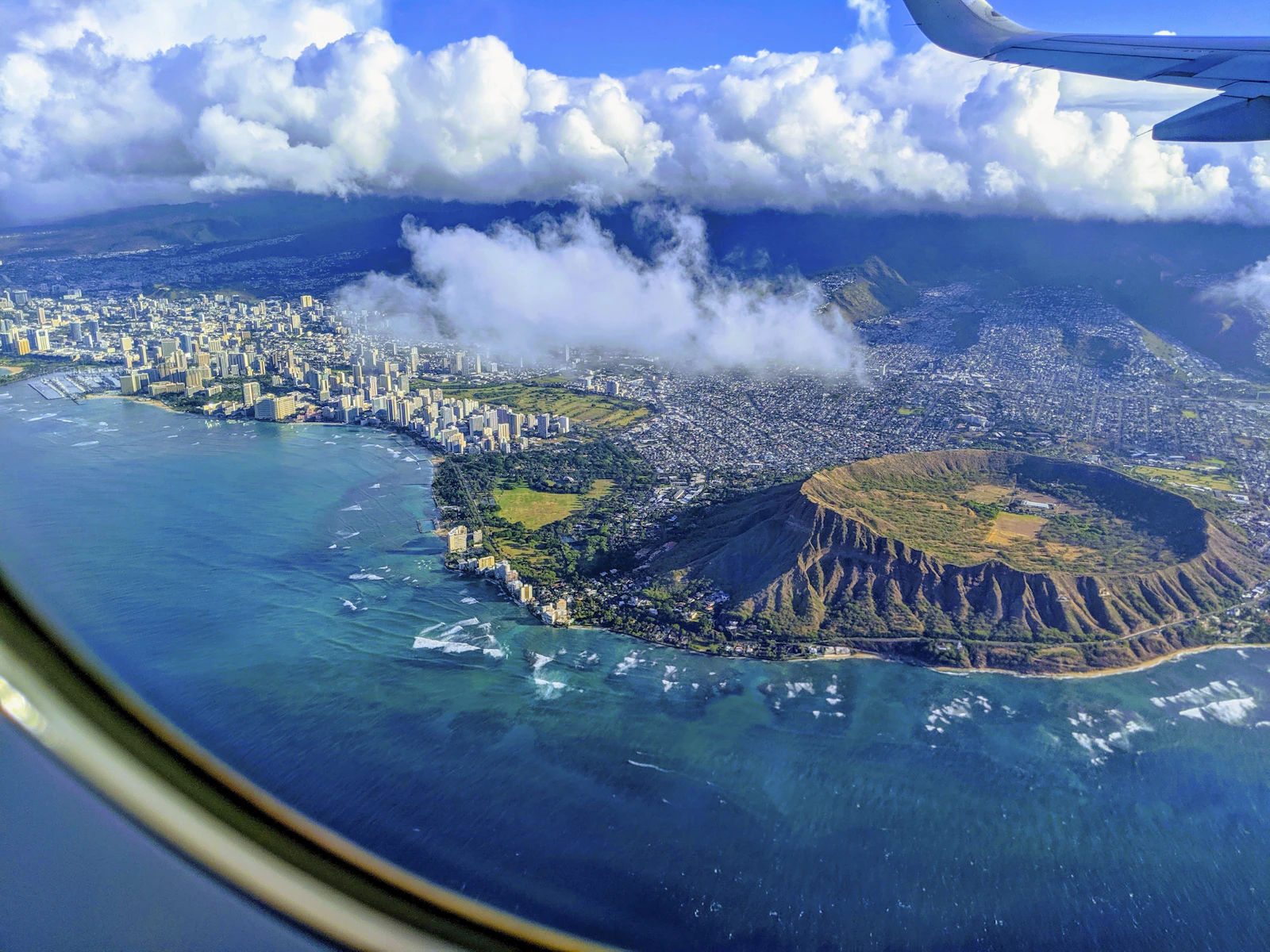 Diamond Head crater from above — $5 per person with online reservation (mandatory), free for Hawaii residents; a 300,000-year-old volcanic tuff cone with WWII fortifications inside the crater walls